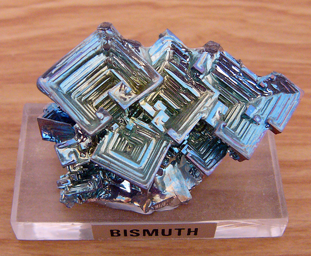 An iridescent bismuth crystal with stepped geometric faces.