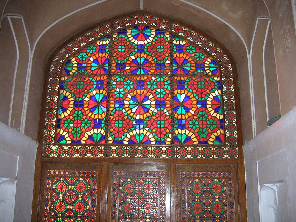 Colored pieces arranged in a patterned window.